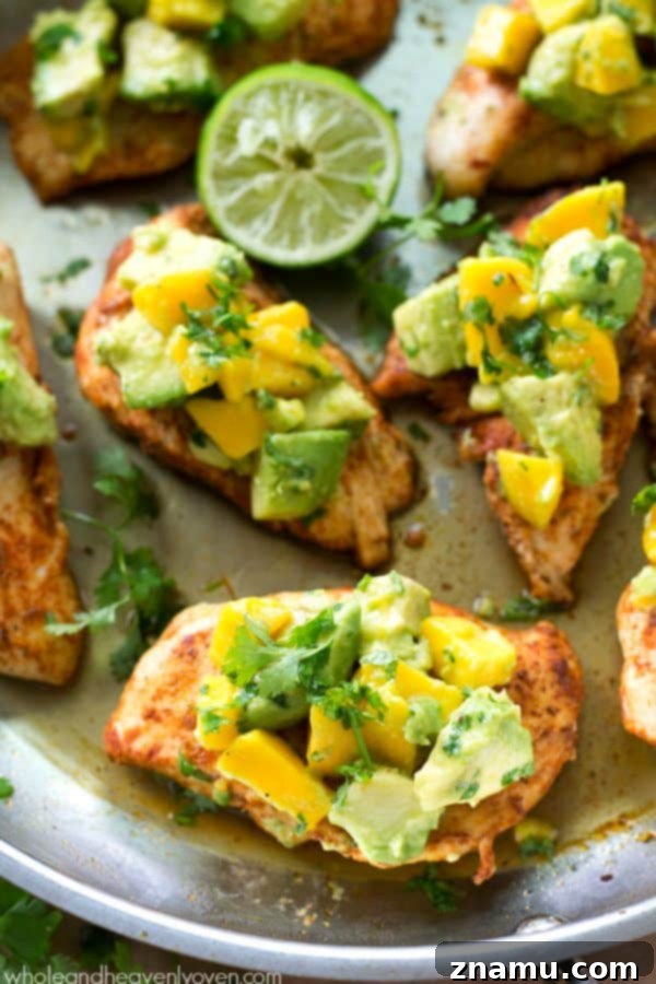 Extra-juicy, cajun-rubbed chicken tenders are piled high with a sweet 'n' spicy mango avocado salsa for one super-easy and flavorful weeknight chicken dinner!