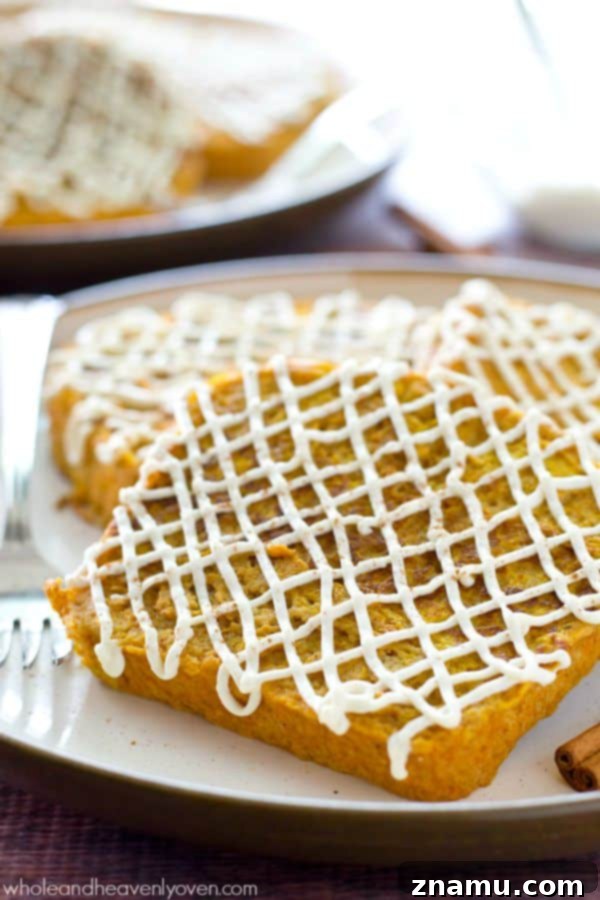 Decadent Pumpkin Cheesecake French Toast 3 Close-up of golden-brown Pumpkin Cheesecake French Toast with a thick layer of glaze.