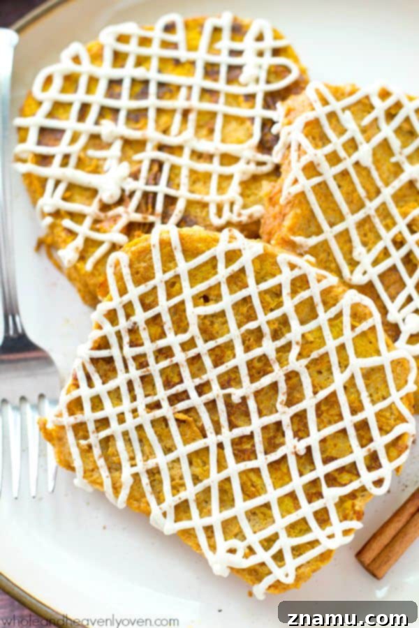 Decadent Pumpkin Cheesecake French Toast 7 Several slices of Pumpkin Cheesecake French Toast on a plate, ready to be served.