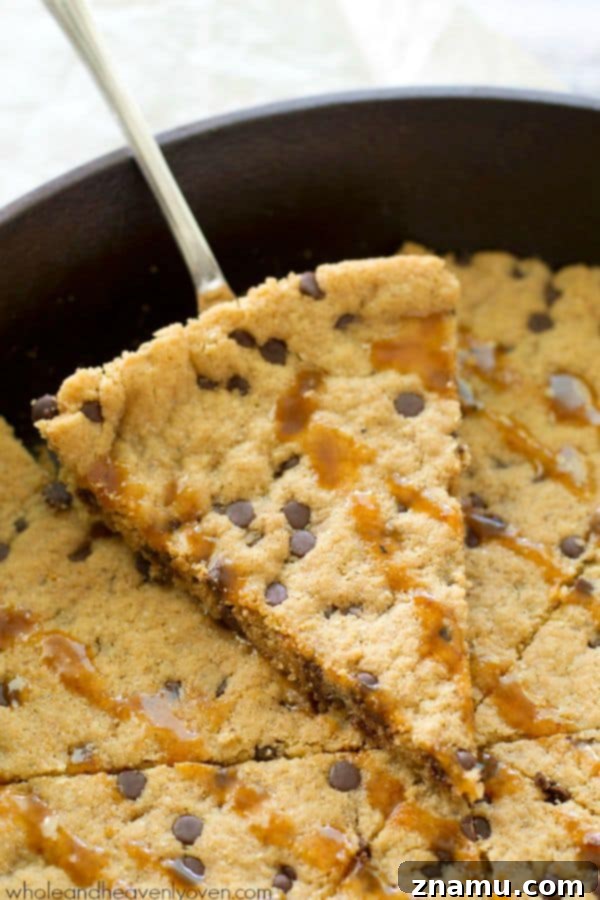 Gooey Flourless Caramel Chocolate Chip Skillet Cookie 6 A generous serving of gooey caramel drizzled over the warm flourless chocolate chip skillet cookie, creating an irresistible dessert. @WholeHeavenly