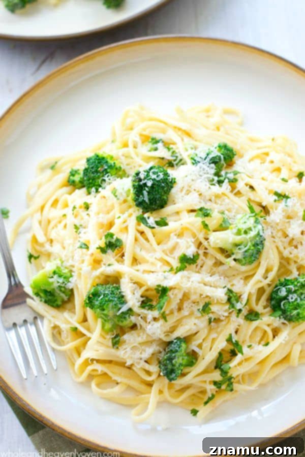 Broccoli Garlic Fettuccine Alfredo in 20 Minutes 2 Deliciously creamy fettuccine alfredo with fresh broccoli and parmesan cheese in a bowl, ready to eat.