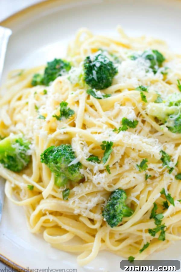 Broccoli Garlic Fettuccine Alfredo in 20 Minutes 4 A large pot filled with fettuccine alfredo, broccoli, and parmesan cheese, ready to be served.