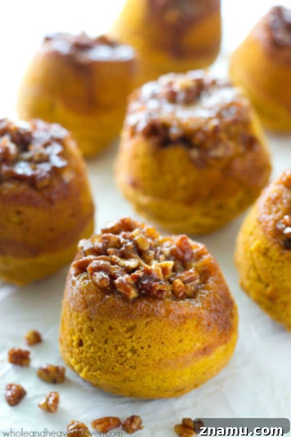 Gooey Pecan Pumpkin Flip Muffins 3 Close-up of a sticky pecan upside-down pumpkin muffin, showing the rich pecan topping.