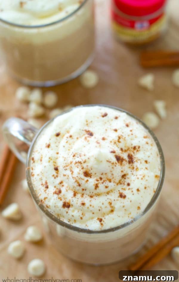 Pumpkin Spice White Chocolate Mocha 5 A cozy scene featuring a White Chocolate Pumpkin Spice Mocha with a book, perfect for a relaxing moment.