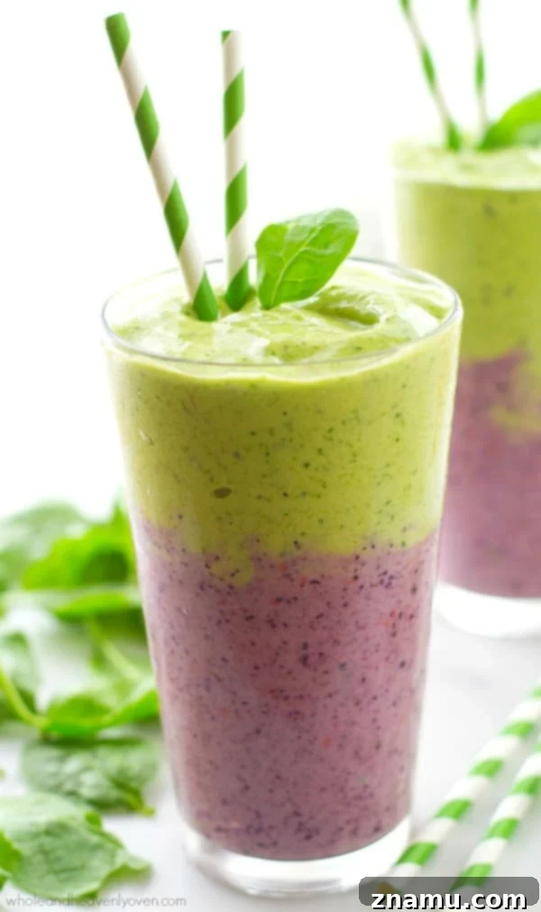 PB&J Power Up Smoothie 11 Visually stunning layered smoothie with green and berry-colored layers, promoting health and power.