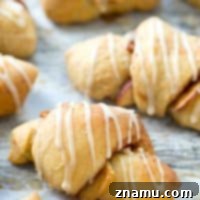 Filled with sugary spiced apples and covered to perfection with glaze, these pillow-soft crescent rolls are a fall brunch favorite that no one will be able to resist!