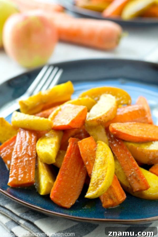 Moroccan Maple Caramelized Carrots and Apples 3 Close-up of roasted carrots and apples glistening with maple syrup and Moroccan spices, a perfect easy fall side for any dinner table.