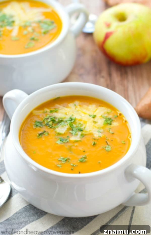 Spiced Sweet Potato Apple Bisque 5 A serving of creamy sweet potato and apple soup garnished with shredded Asiago cheese.