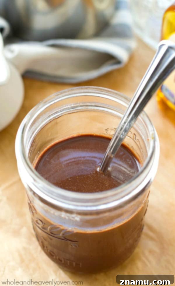 Easy 4-Ingredient Agave Mocha Coffee Syrup 3 Agave Mocha Coffee Syrup being drizzled into a steaming cup of coffee.