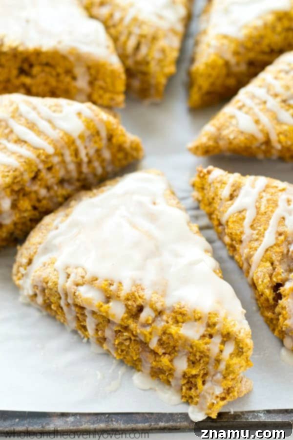 Autumn Cafe Pumpkin Spice Scones 7 A beautifully plated pumpkin spice scone with a generous drizzle of vanilla glaze.