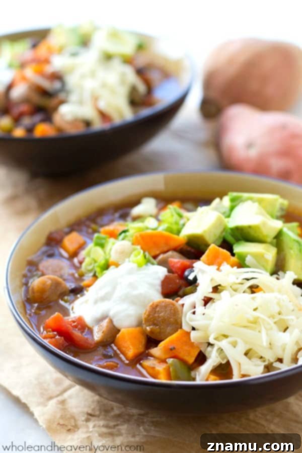 Hearty Slow Cooker Sweet Potato Sausage Chili 5 Another perspective of a bowl of Crockpot Sweet Potato Sausage Chili, showcasing the texture and toppings.