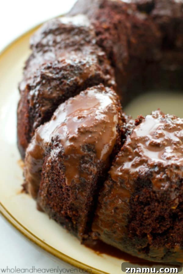 Decadent Birthday Chocolate Bundt Cake 4 Chocolate bundt cake sitting on a cake stand, ready for slicing.