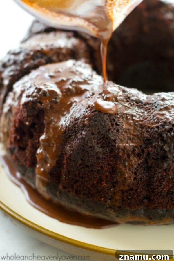 Decadent Birthday Chocolate Bundt Cake 7 Overhead view of a chocolate bundt cake slice with a fork, emphasizing its moistness.