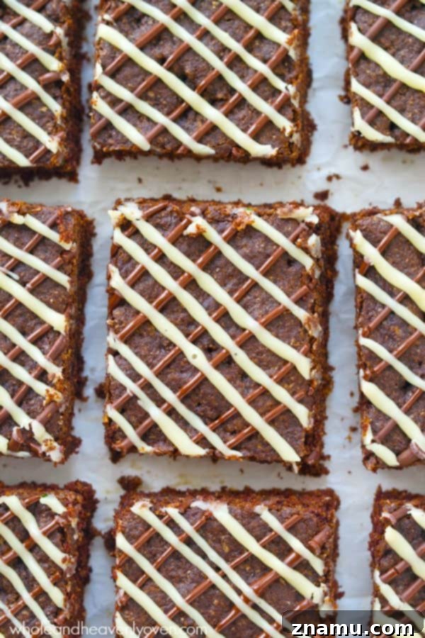 Decadent Triple Chocolate Chewy Bars 6 Close-up of a stack of freshly baked, soft, and chewy triple chocolate cookie bars. A decadent dessert for any occasion. @WholeHeavenly