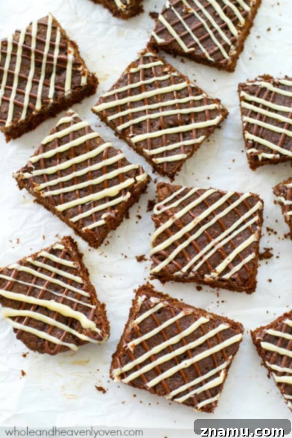 Decadent Triple Chocolate Chewy Bars 7 Perfectly baked triple chocolate chewy cookie bars with a delightful drizzle, ready to be enjoyed. A perfect treat for sweet cravings. @WholeHeavenly