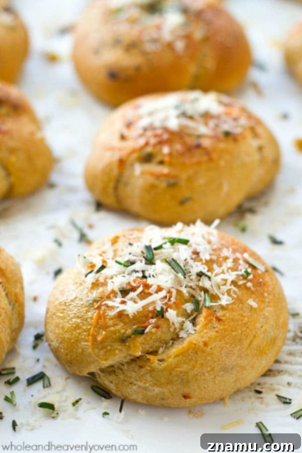 Garlic Rosemary Parmesan Knots 3 Close-up of fluffy Parmesan Garlic Rosemary Knots, showcasing their golden crust and herb topping, perfect for a Thanksgiving feast.