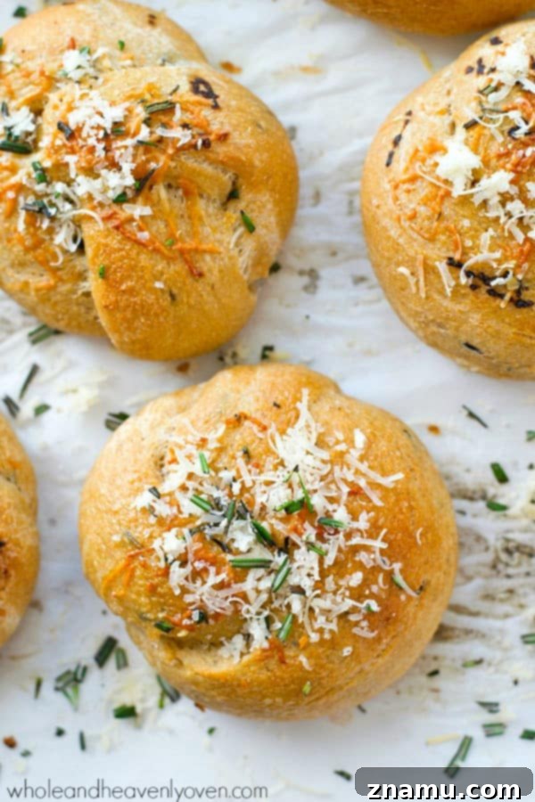 Garlic Rosemary Parmesan Knots 4 A basket of freshly baked Parmesan Garlic Rosemary Knots, perfectly golden brown and dusted with cheese, ready to be served.