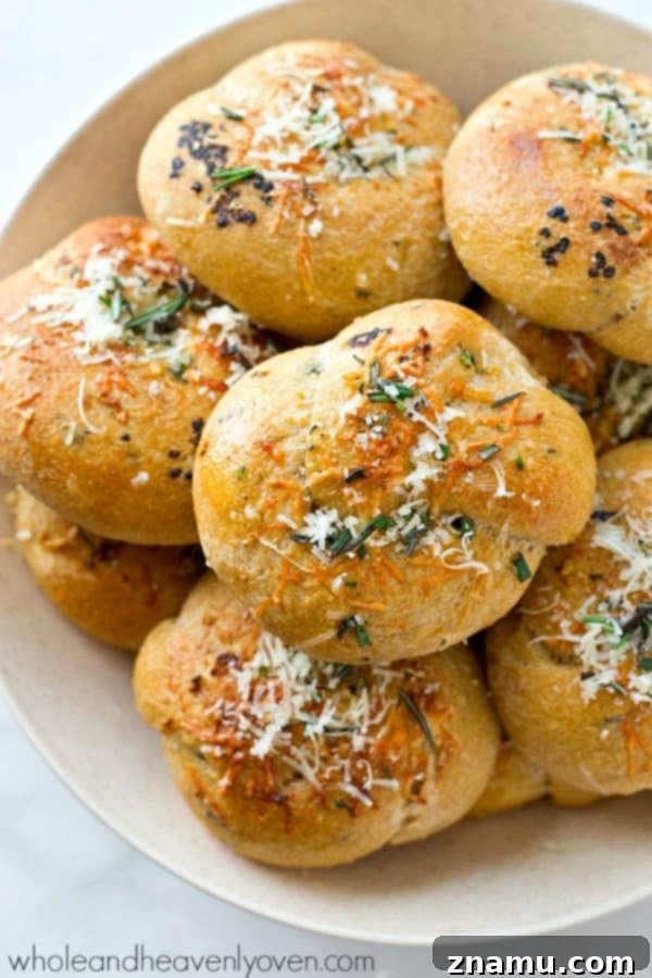 Garlic Rosemary Parmesan Knots 5 Close-up view of the golden-brown Parmesan Garlic Rosemary Knots, featuring the rich texture and herb speckles from fresh rosemary.