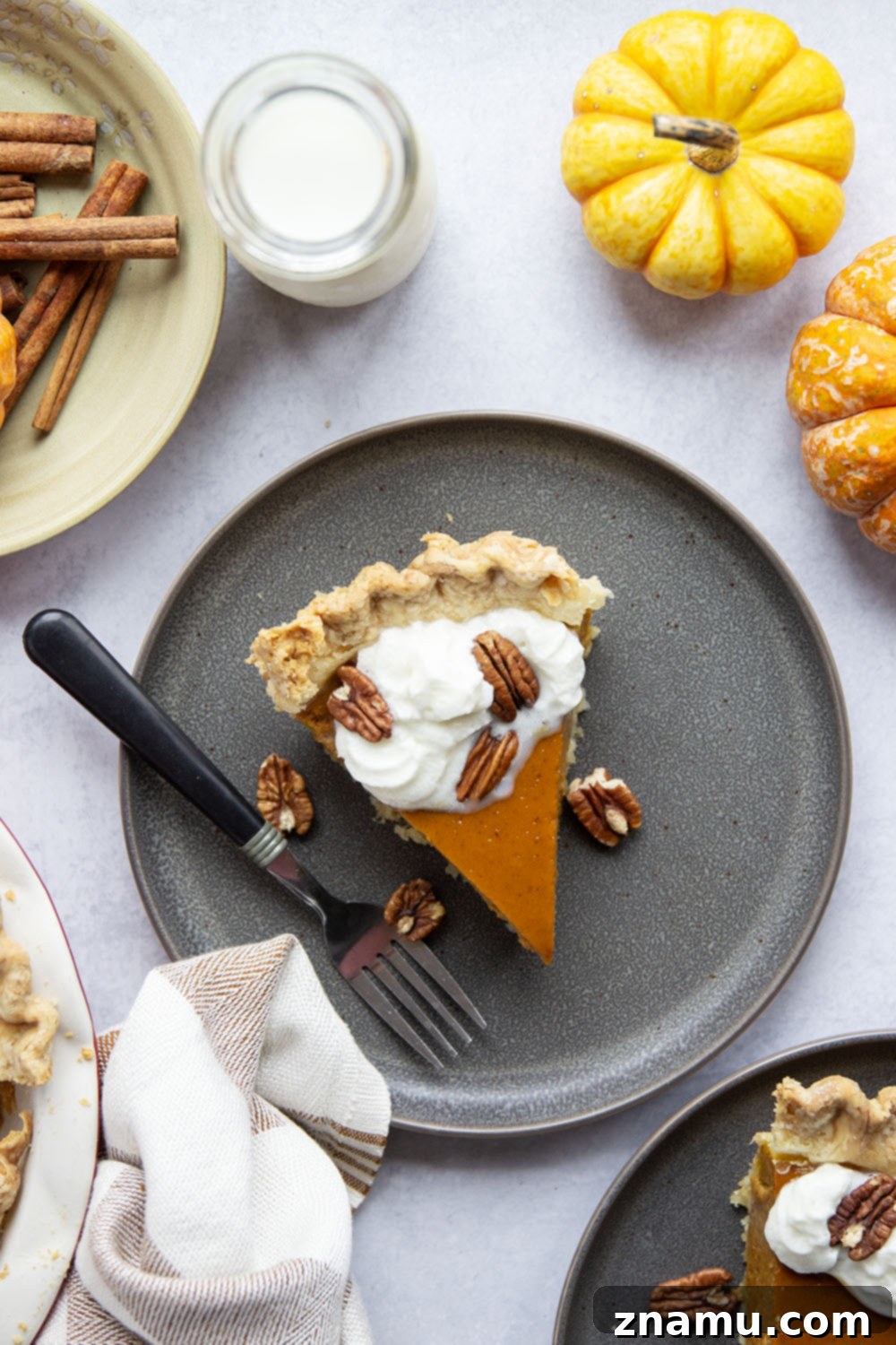 The Ultimate Pumpkin Pie 6 Close-up of a perfectly baked pumpkin pie with a golden crust, ready to be sliced.