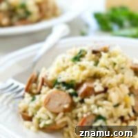 Creamy restaurant-style parmesan risotto loaded with plenty of sausage and kale, and made in one pot in only 30 minutes! Dinner is going to rock.