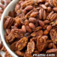 Roasted to perfection in maple syrup and spices, these candied pecans and almonds make the ultimate holiday snack or gift!