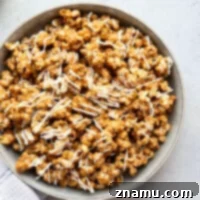 Coated in a gingerbread-spiced caramel sauce and drizzled with plenty of white chocolate, this dynamite gingerbread caramel popcorn is nearly impossible to stop eating!