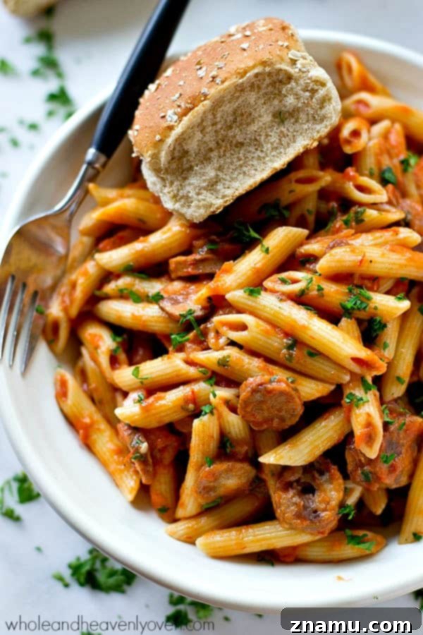 Effortless 30-Minute Penne Vodka with Sausage 2 Penne pasta and sliced chicken sausage simmering in a rich, creamy vodka sauce in a cast iron dutch oven.
