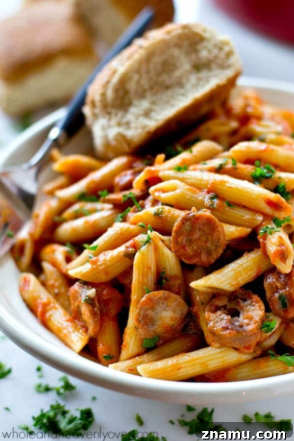 Effortless 30-Minute Penne Vodka with Sausage 7 A wooden cutting board with fresh basil, thyme, and red pepper flakes, ready for garnishing penne alla vodka.