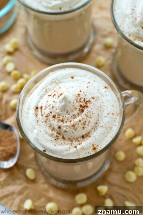 Close-up of creamy white hot chocolate brewing in a crockpot, infusing with aromatic chai spices for a perfect holiday drink.