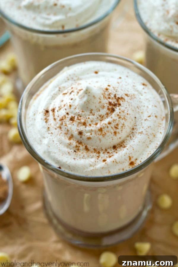 Garnished mug of chai-spiced white hot chocolate, showcasing the creamy texture and inviting warmth of this simple crockpot recipe.