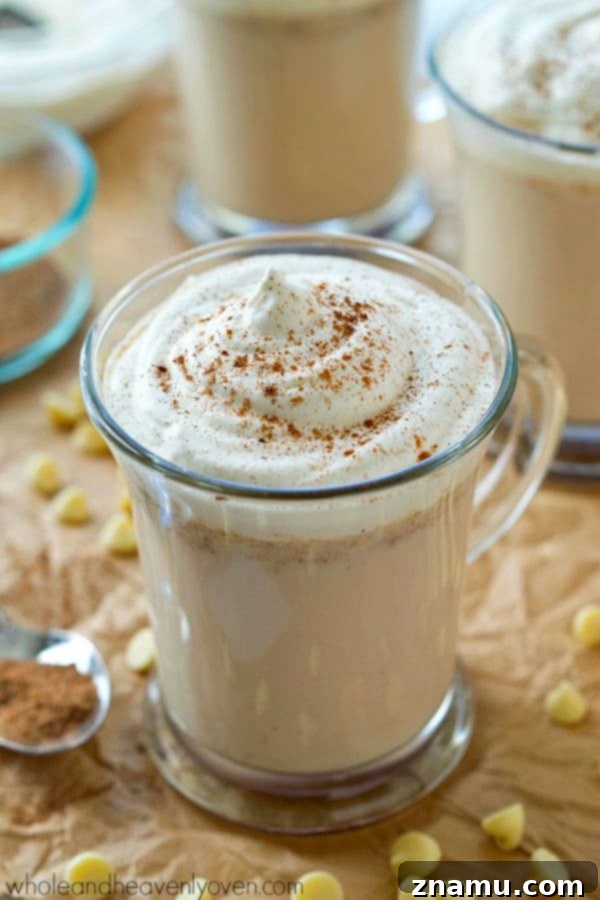 Overhead shot of white hot chocolate with a rustic backdrop, highlighting the delicious blend of chai spices and white chocolate for a winter treat.