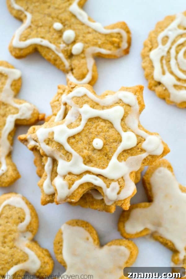 Coconut-Infused Eggnog Sugar Cookie Cut-Outs 6 Close-up of a hand holding a freshly baked coconut oil eggnog cookie.