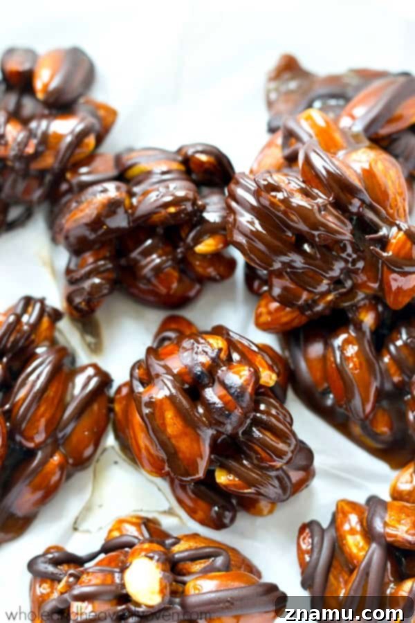 Almond Caramel Dark Chocolate Bites 4 Dark Chocolate Caramel Almond Clusters piled high, ready to be enjoyed as a sweet snack or dessert.