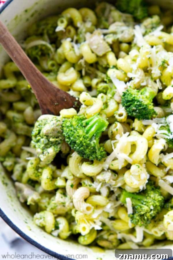 Close-up of healthy chicken basil pesto pasta skillet with vibrant greens
