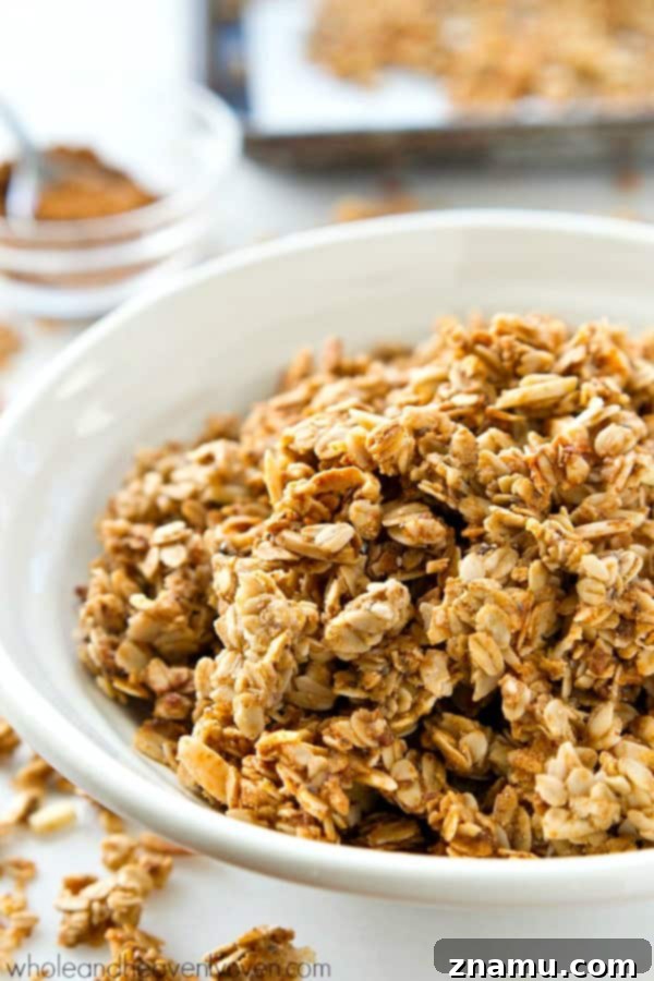 A close-up shot of crispy almond butter chai spice granola, highlighting the rich, golden color and distinct spice grains