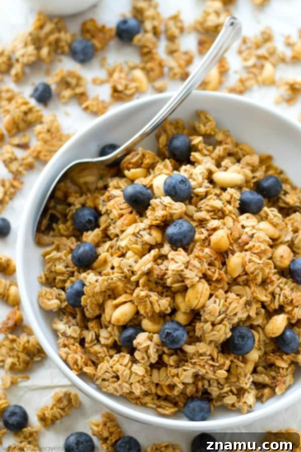 You won't believe that this loaded peanut butter granola is good for you! It's so crunchy, peanut butter-y and addicting, you'll want to eat it all straight from the pan!