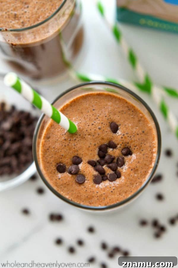 Rise and Shine Mocha Smoothie 5 A glass of Cafe Mocha Breakfast Smoothie garnished with chocolate chips and whipped cream.