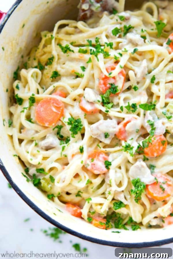 Creamy One-Pot Chicken Pot Pie Fettuccine 3 Close-up of One-Pot Chicken Pot Pie Fettuccine with fresh parsley garnish.