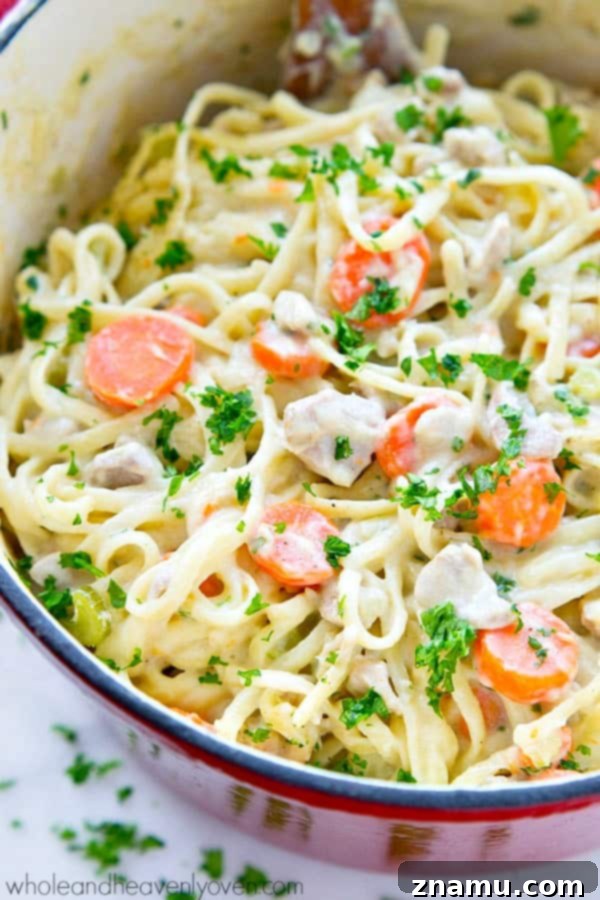 Creamy One-Pot Chicken Pot Pie Fettuccine 5 One-Pot Chicken Pot Pie Fettuccine simmering in a deep pan, nearly ready.