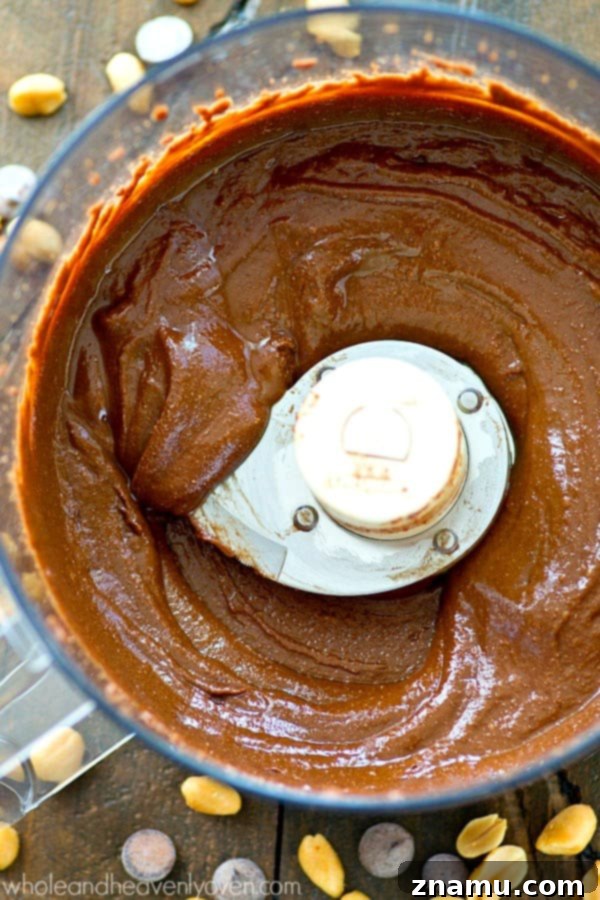 Homemade Dark Chocolate Snickerdoodle Peanut Butter 5 A delectable swirl of Dark Chocolate Snickerdoodle Peanut Butter in a food processor