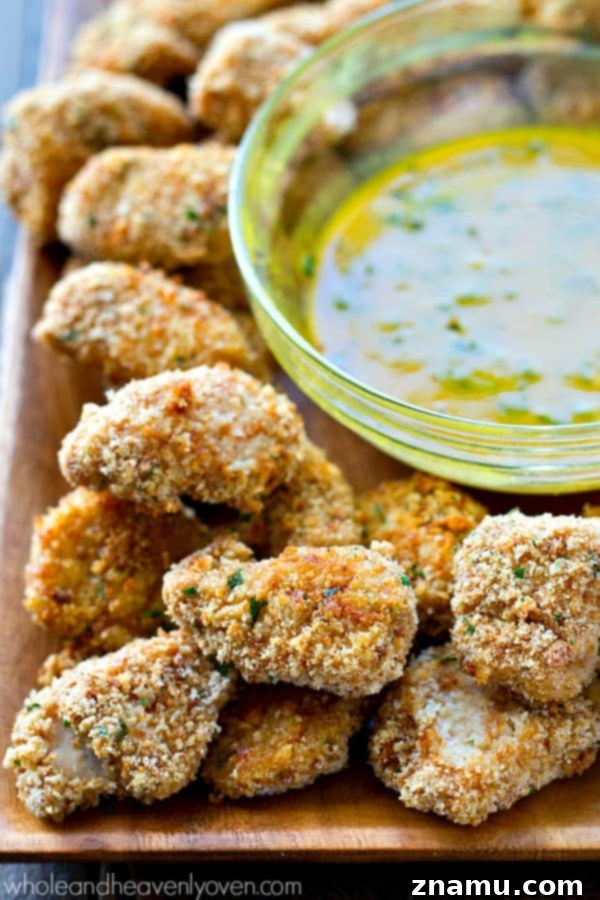 Golden Crunch Baked Chicken Bites with Zesty Honey Mustard 7 Overhead shot of freshly baked, extra-crispy chicken nuggets on a wire rack, cooling slightly after being removed from the oven.