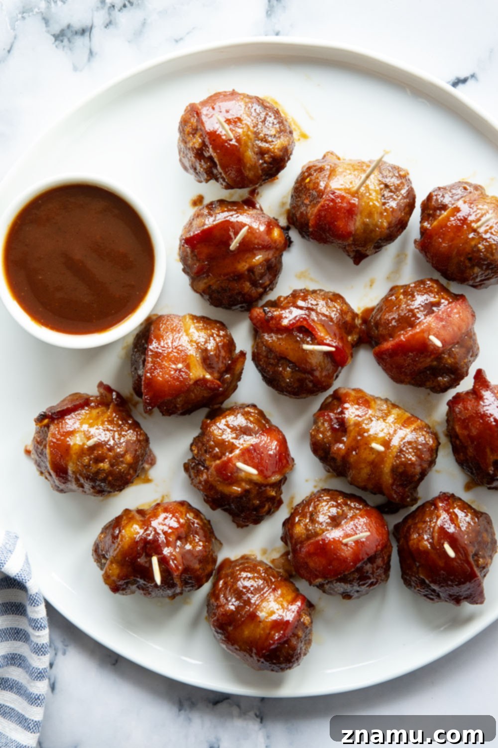 Sweet & Smoky Bacon BBQ Turkey Meatballs 2 Juicy BBQ turkey meatballs are wrapped in bacon and baked in a sweet and tangy brown sugar barbecue sauce for the best 2-bite appetizer!