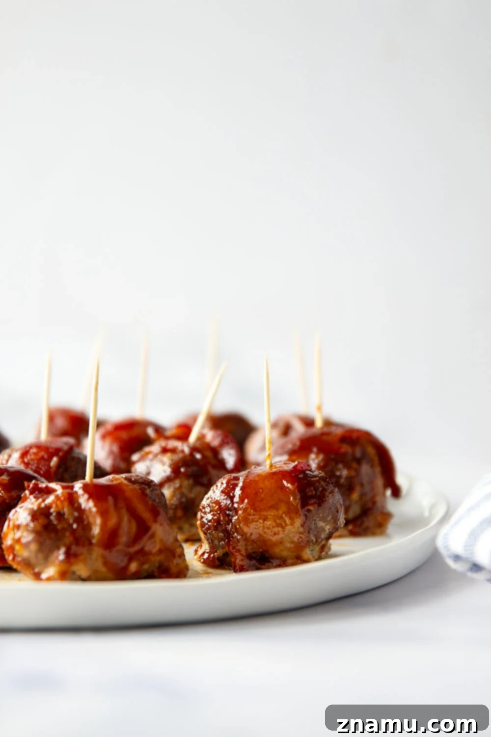 Sweet & Smoky Bacon BBQ Turkey Meatballs 5 Juicy BBQ turkey meatballs are wrapped in bacon and baked in a sweet and tangy brown sugar barbecue sauce for the best 2-bite appetizer!