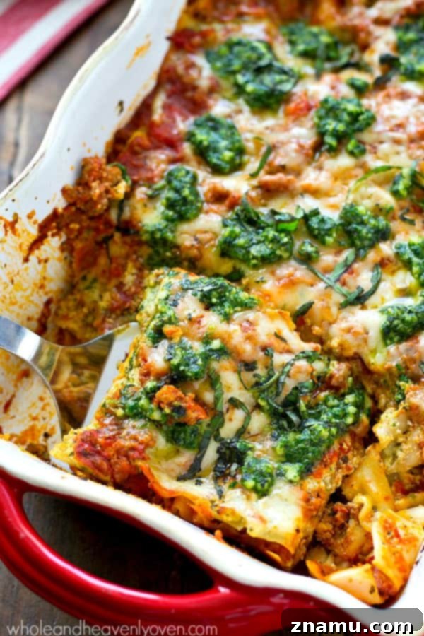 Triple Cheese Pesto Turkey Bake 2 A large baking dish filled with bubbling, golden-brown turkey pesto lasagna, topped with melted cheese and fresh basil