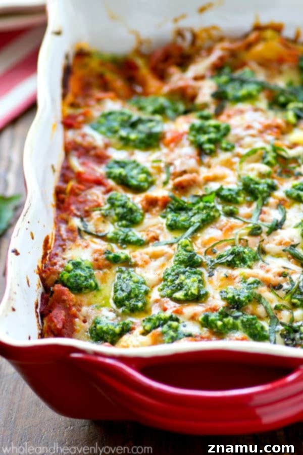 Triple Cheese Pesto Turkey Bake 3 Close-up of a delicious slice of turkey pesto lasagna, revealing creamy ricotta and rich meat sauce layers