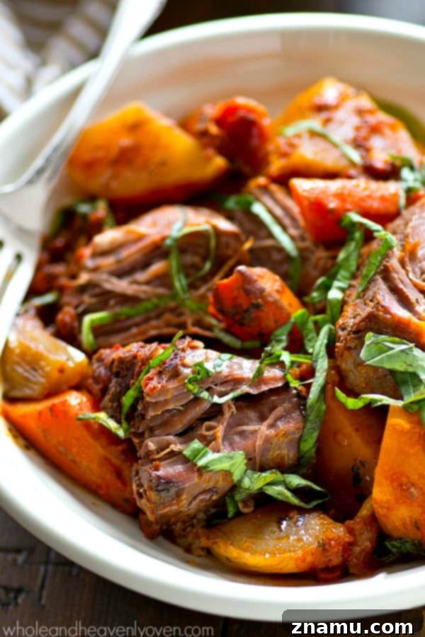 Close-up of slow-cooked Italian pot roast, showcasing tender beef and colorful root vegetables.