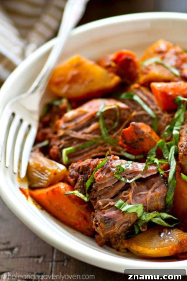 An assembled Italian pot roast in a slow cooker, ready for cooking.