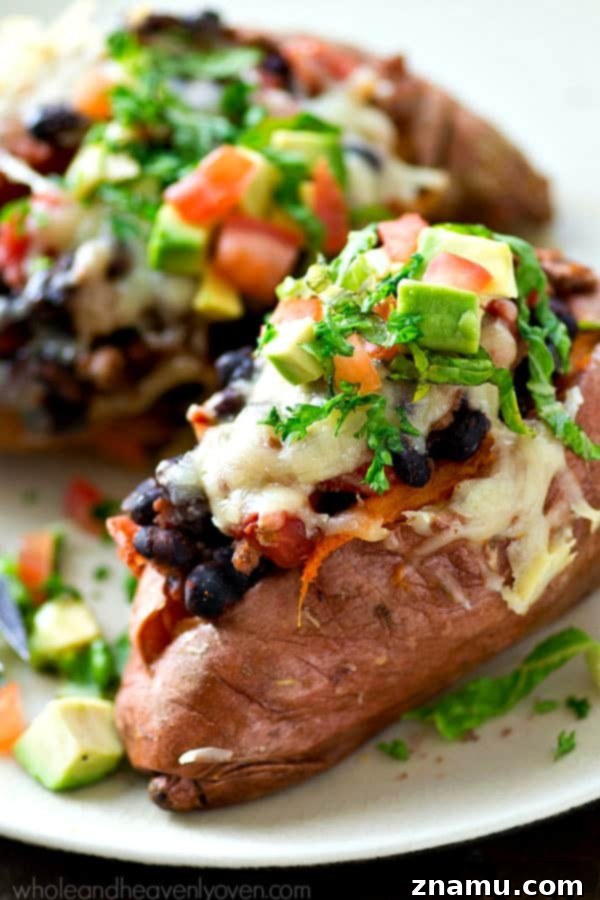 Fiesta Loaded Sweet Potato Shells 7 A serving of stuffed sweet potatoes with a side of fresh toppings and a fork