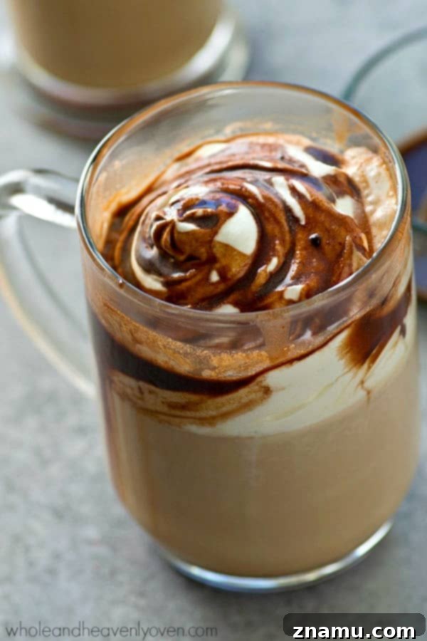 A decadent Mint Mocha Latte, generously topped with whipped cream and drizzled with a homemade chocolate-mint syrup.