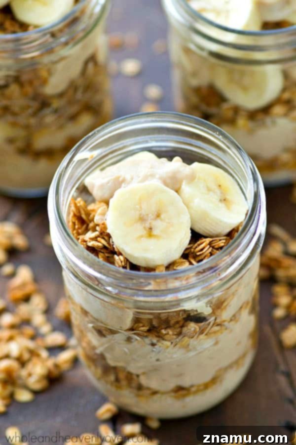 Banana Cream Pie Parfaits with Granola Crunch 3 Close-up shot of a layered banana cream pie granola parfait, showing rich vanilla pudding, granola, and sliced bananas.